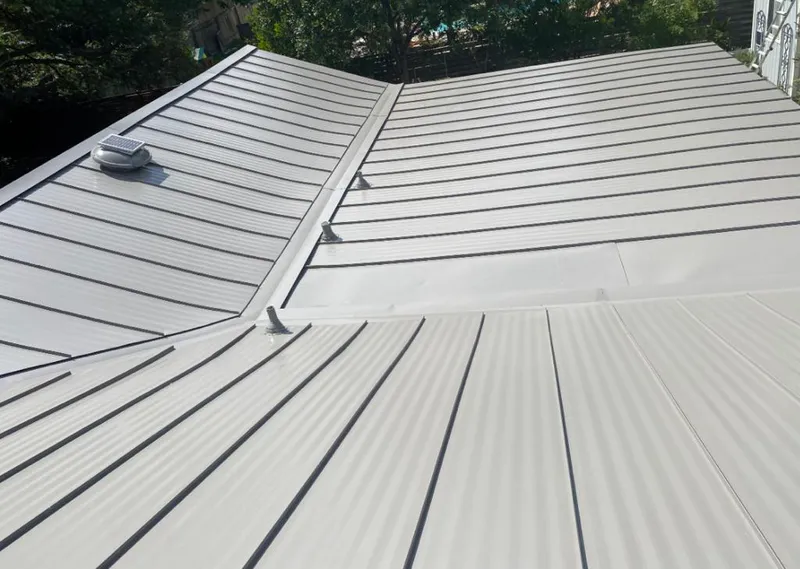 Solar attic fan installed on a metal roof for Roof Ventilation in Casselberry