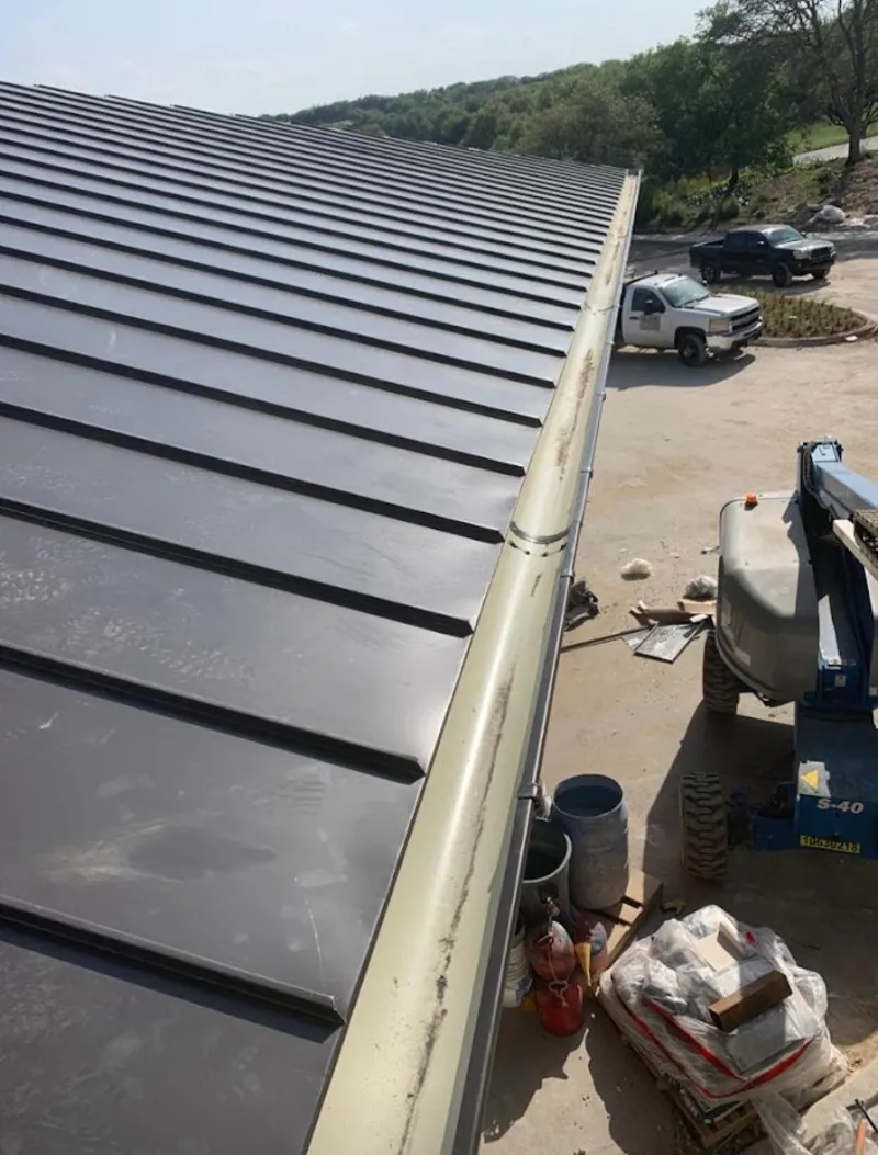 Standing seam panel and gutter detail on a metal roofing jobsite in Casselberry